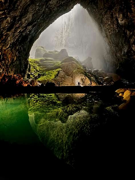 man-standing-on-bridge in huge cavern