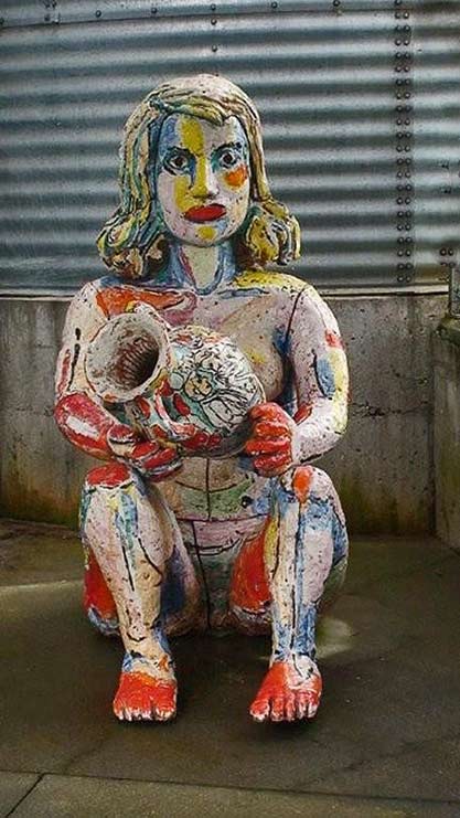 colourful ceramic-sculpture of a seated woman holding a pot by Viola Frey