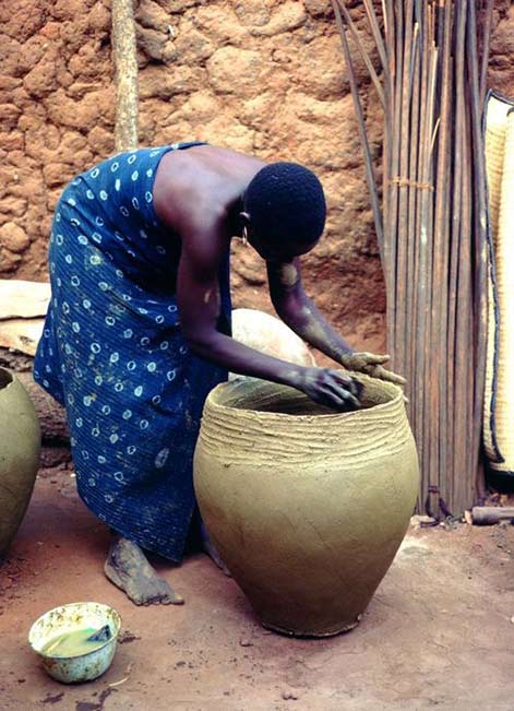 hand crafting a large clay pot - Mali