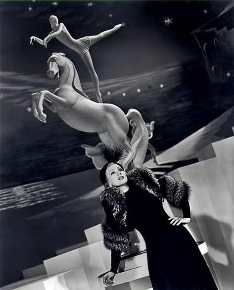 actress Ann Sothern with circus acrobat on horde statue