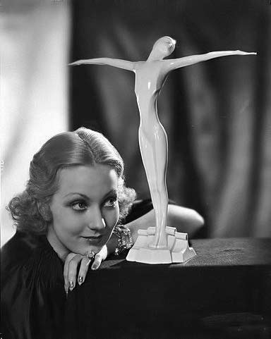 Ann-Sothern and white female figurine statue