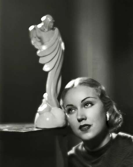 Fay-Wray posing with white art deco sculpture