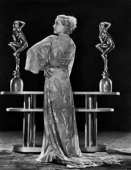 Helen-Twelvetrees posing with to art deco figure sculptures