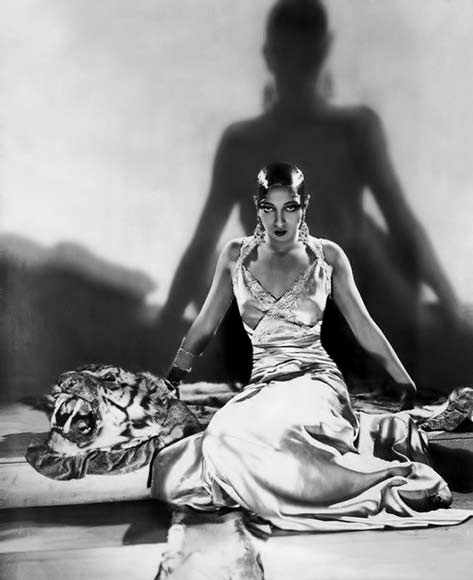 Josephine Baker sitting on tiger skin rug