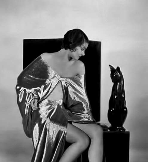 Myrna-Loy with a black cat sculpture