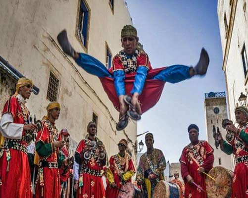 Gnawa musicians and leaping dancer 