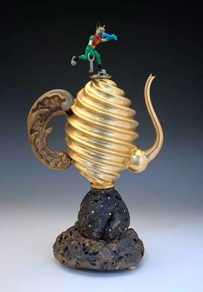 Adrian-Saxe gold swirl teapot with rock base