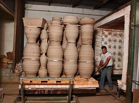 Loading the kiln with large garden pots on a trolly - Cretan-Terracotta Pottery