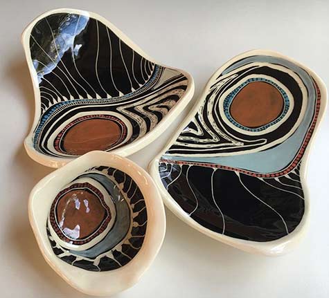 Three amorphic dishes with aboriginal art decoration