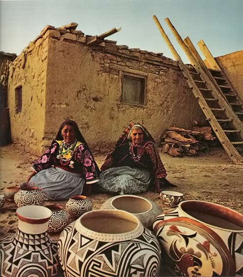 Pueblo-Native-American-women displaying their pottery