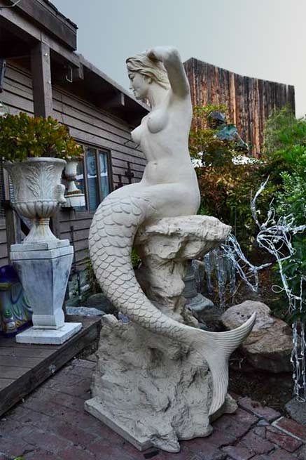 white mermaid on rock sculpture