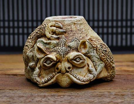 Tonomo Misao carved ceramic cup with animal reliefs