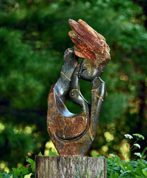 In Harmony With Nature by Simon Chidharara A girl holding a bird sculpture