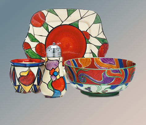 Clarice Cliff-ceramics Comprising-a-platter,-a-centerpiece-bowl-in-the-‘Bizarre’-‘Persian’-pattern,-and-a-vase,-together-with-a-caster-with-metal-cover