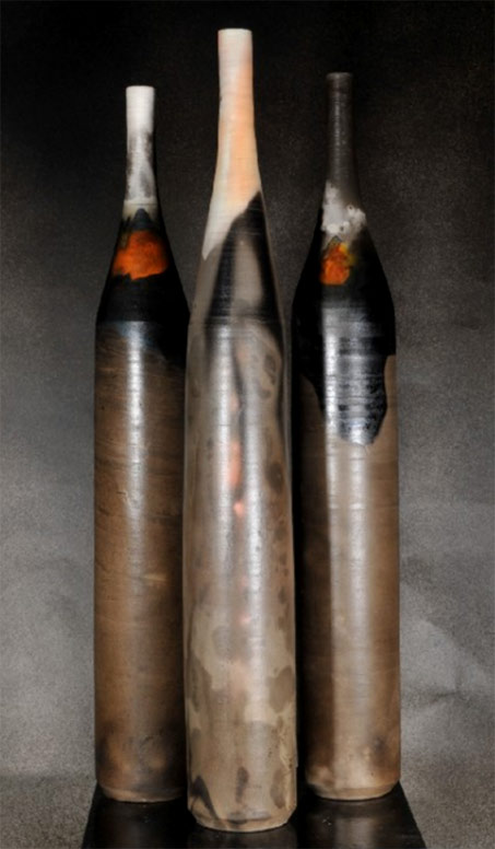 Three tall slender ceramic bottles -- Donve BRanch