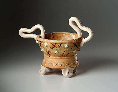 Footed ceramic vessel with asymmetrical handles