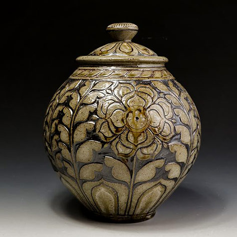 Wheel thrown ceramic jar with lid -- Kate Johnston-cone-12-in-a-large-cross-draft-wood-salt-Kiln.-Carved-patterns,-inlaid-slip,-and-paining-with-glaze