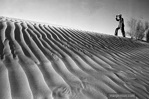 Sands of the desert---Max Penson-- a man walking on a sandune