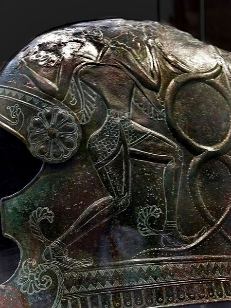 Cretan helmet with the image of Hermes holding snakes. 7th century BCE.