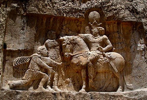Rock face relief at Naqsh-e Rustam of Persian emperor Shapur I -(on-horseback)-capturing-Roman-emperors-Valerian-(kneeling)-and-Philip-the-Arab-(standing)