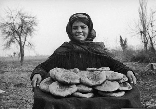 The-girl-is-an-Uzbek girl with national bread on a tray---Max Penson