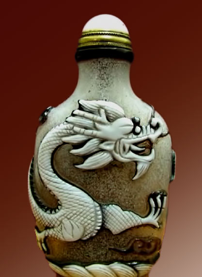 White dragon snuff bottle with orange stopper