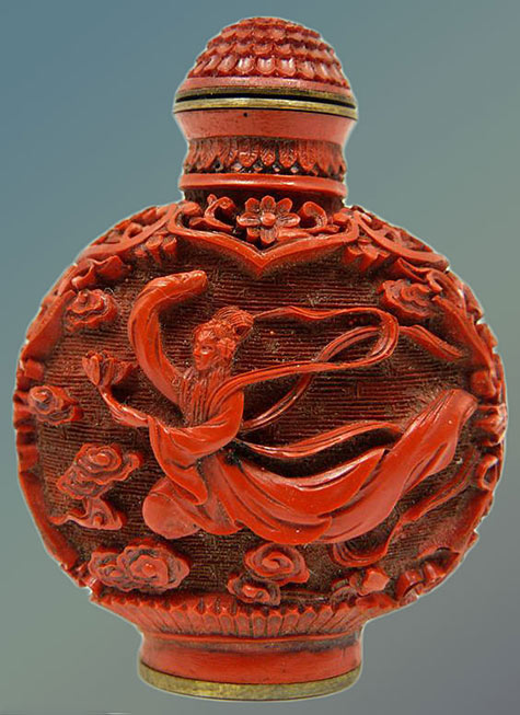Chinese lacquered cinnabar snuff bottle depicting flying Guan Yin to each side. Holds Qianlong (1736-1795)