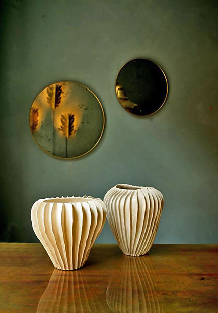 Two white colored vases with vertical ribs by Claudia Frignani