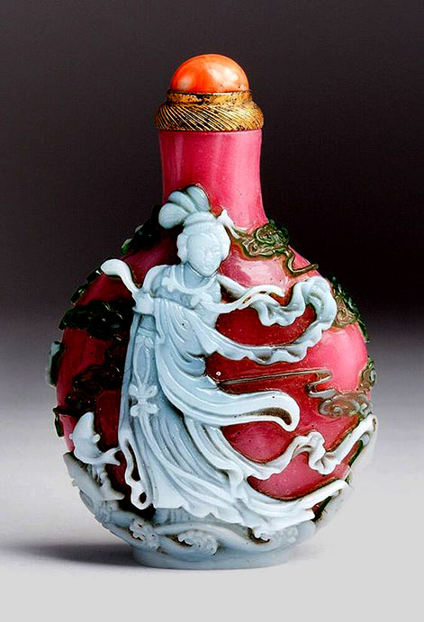 Kuan Yin snuff bottle, white overlay on crimson red