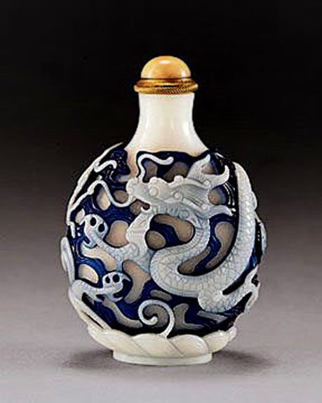 Carved overlay dragon snuff bottle in blue and white