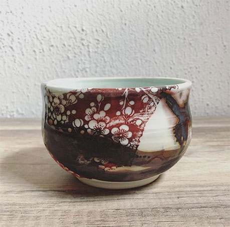 Porcelain celadon teabowl--pattern is an underglaze transfer