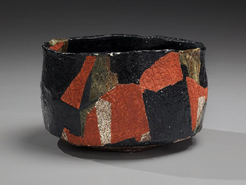 --Black-glazed teabowl with red and olive-green slip-glaze patterning and impressed surface