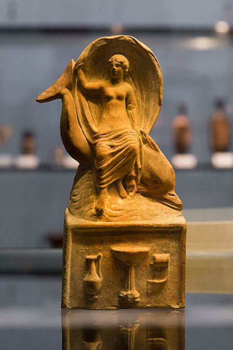 Aphrodite riding a dolphin over the sea. The sweeping movement of the cloth, far over the head of the goddess, represents the speed of the movement. Terracotta from Myrina, Greece, 1st cen. BC
