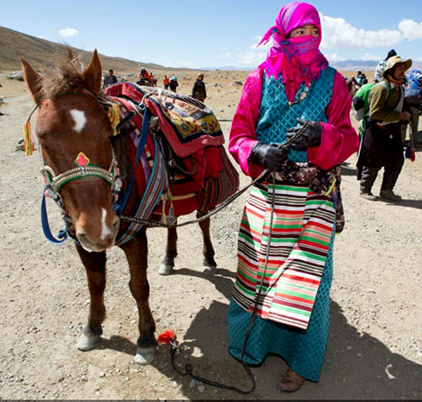 Horse and Tibetan lady porter