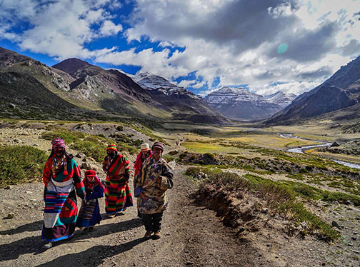 Tibetan pilgrams on mouintain trail