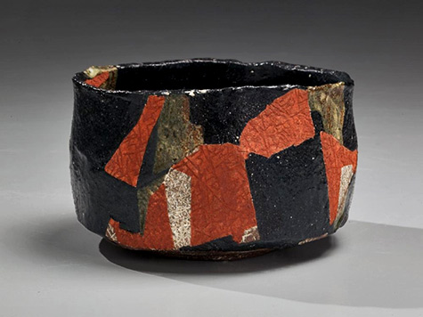 --Black-glazed teabowl with red and olive-green slip-glaze patterning and impressed surface