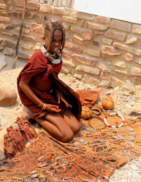 Namibian girl selling clay figures and native jewellry