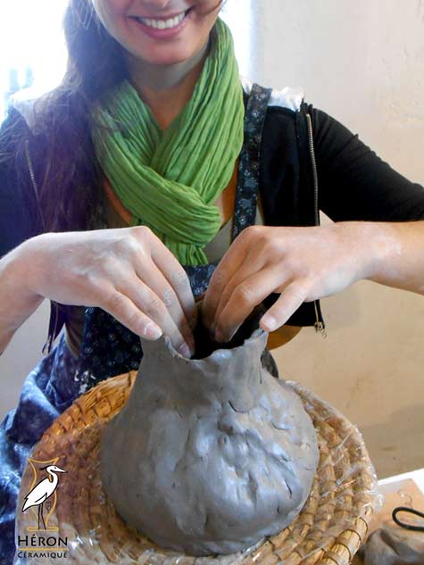 Smiling Cinthia shaping a vase