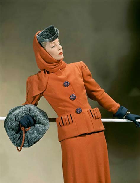 Helen-Bennett-in-orange-suit-with-lilac-colored-buttons-and-lilac-showing-through-the-slit-shoulders-and-pockets,-photo-by-John-Rawlings,-Vogue-1941
